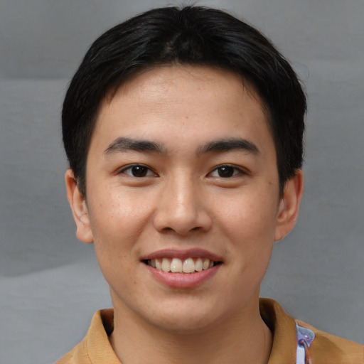 Joyful asian young-adult male with short  brown hair and brown eyes