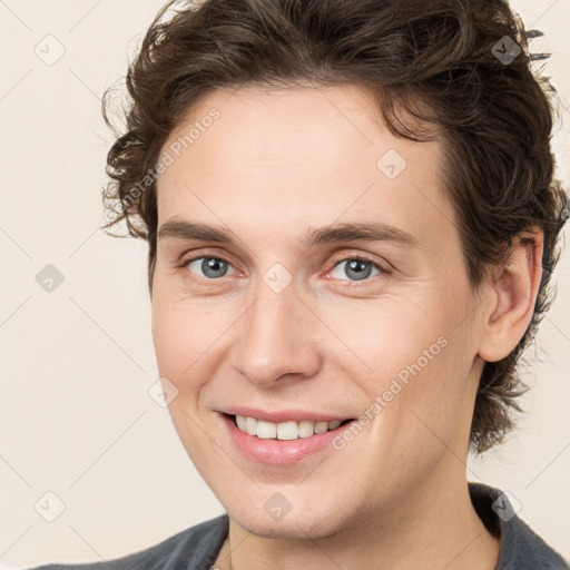 Joyful white young-adult male with medium  brown hair and brown eyes