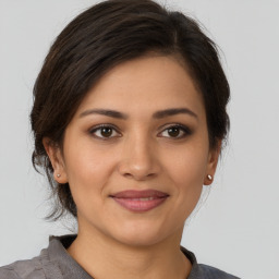 Joyful latino young-adult female with short  brown hair and brown eyes