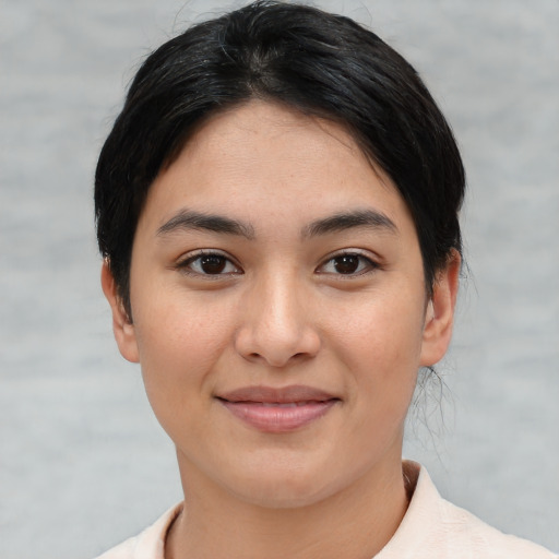Joyful asian young-adult female with short  black hair and brown eyes