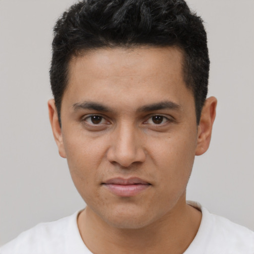 Joyful latino young-adult male with short  brown hair and brown eyes