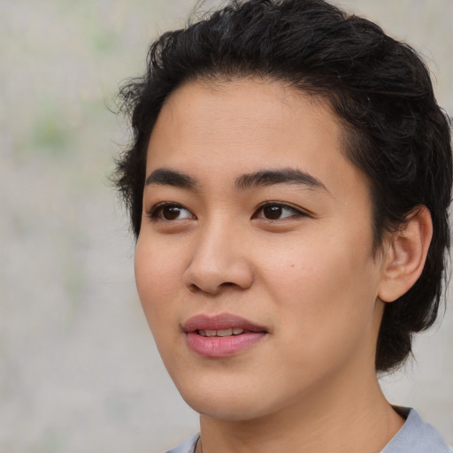 Joyful asian young-adult female with short  black hair and brown eyes