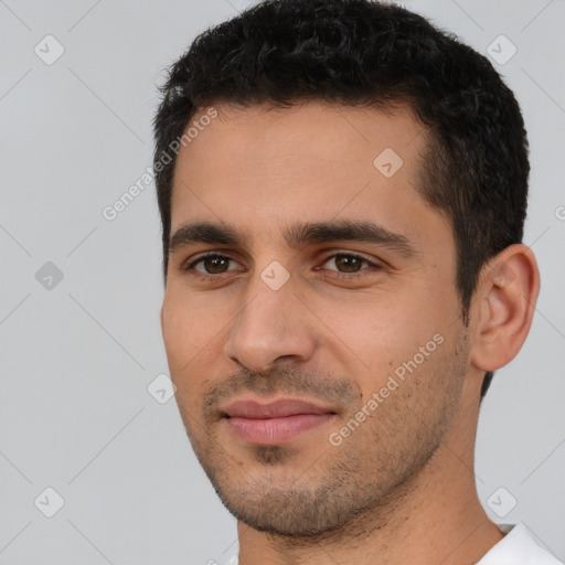 Joyful white young-adult male with short  black hair and brown eyes