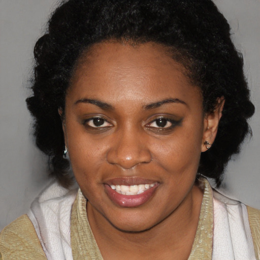 Joyful black young-adult female with long  brown hair and brown eyes