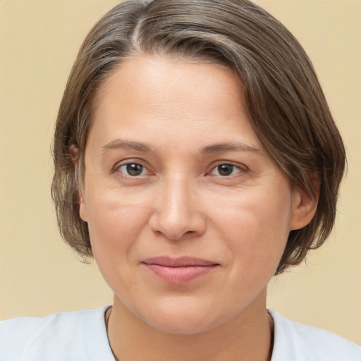 Joyful white adult female with medium  brown hair and brown eyes