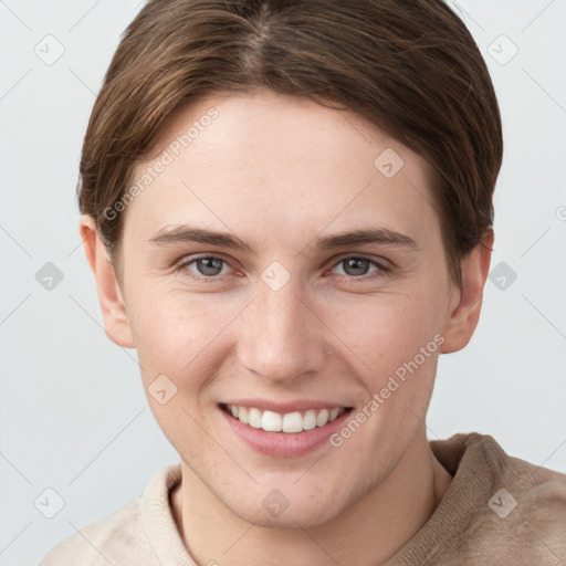 Joyful white young-adult female with short  brown hair and grey eyes