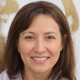 Joyful white adult female with medium  brown hair and brown eyes