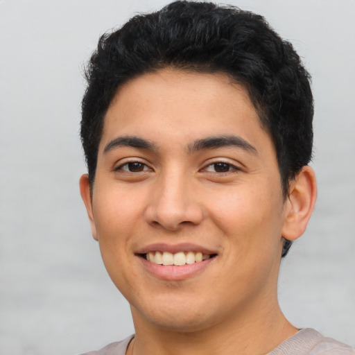 Joyful latino young-adult male with short  black hair and brown eyes