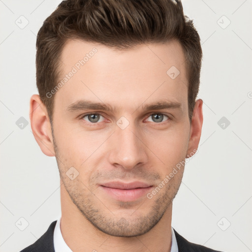 Joyful white young-adult male with short  brown hair and grey eyes