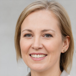 Joyful white adult female with medium  brown hair and brown eyes