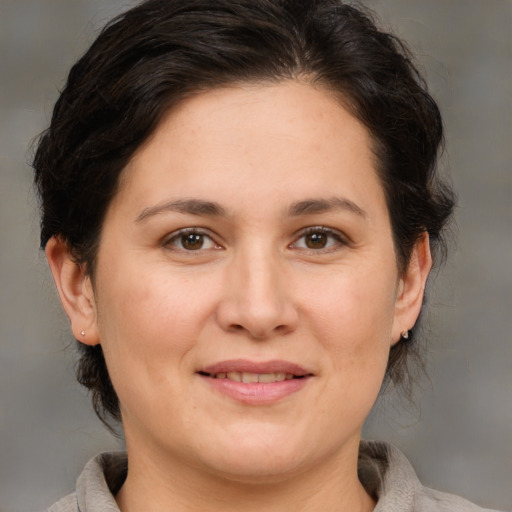 Joyful white adult female with medium  brown hair and brown eyes