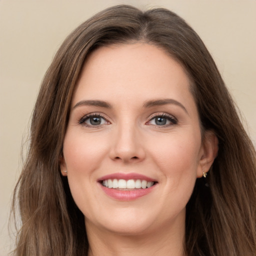 Joyful white young-adult female with long  brown hair and green eyes