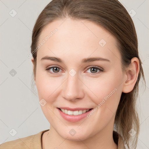 Joyful white young-adult female with medium  brown hair and grey eyes