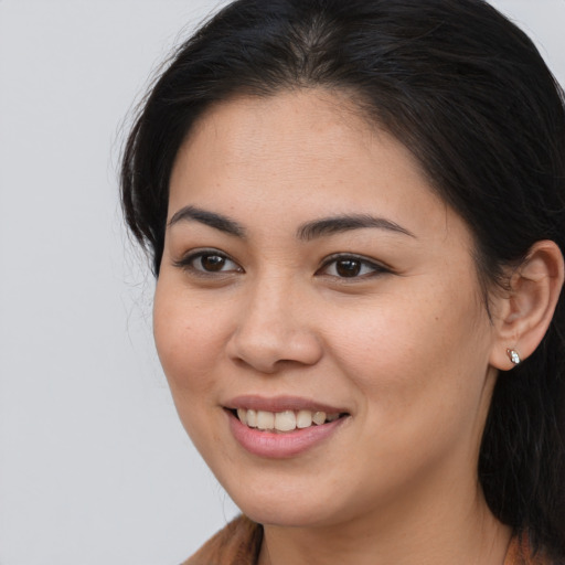 Joyful asian young-adult female with long  brown hair and brown eyes