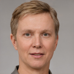 Joyful white adult male with short  brown hair and grey eyes