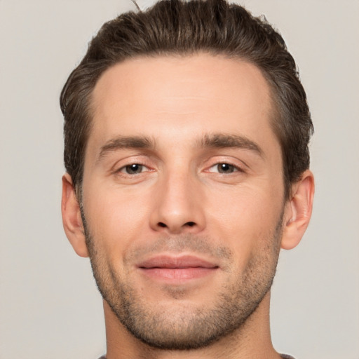 Joyful white young-adult male with short  brown hair and brown eyes