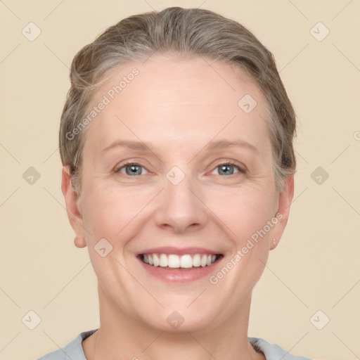 Joyful white adult female with short  brown hair and grey eyes