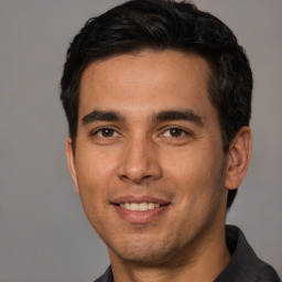 Joyful white young-adult male with short  black hair and brown eyes