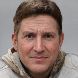 Joyful white adult male with short  brown hair and grey eyes