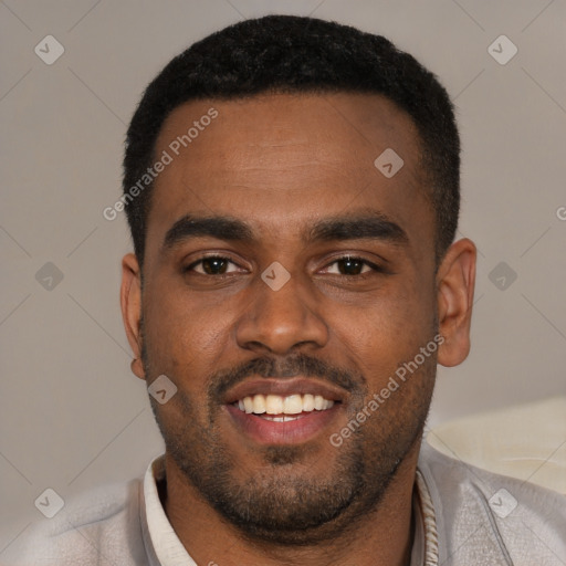 Joyful black young-adult male with short  black hair and brown eyes