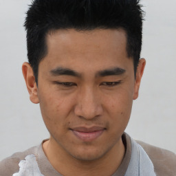 Joyful asian young-adult male with short  brown hair and brown eyes