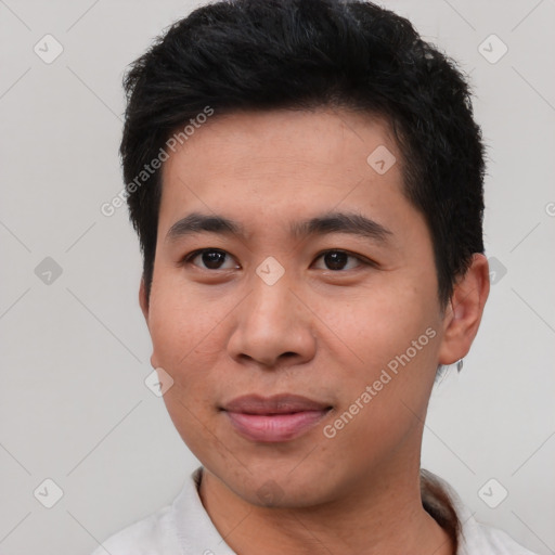 Joyful asian young-adult male with short  black hair and brown eyes