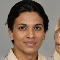 Joyful latino adult female with short  brown hair and brown eyes