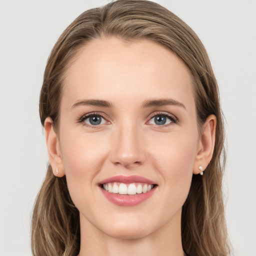 Joyful white young-adult female with long  brown hair and grey eyes