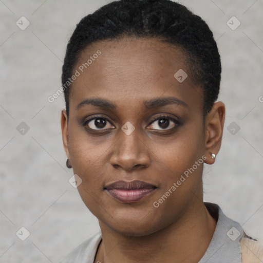 Joyful black young-adult female with short  black hair and brown eyes