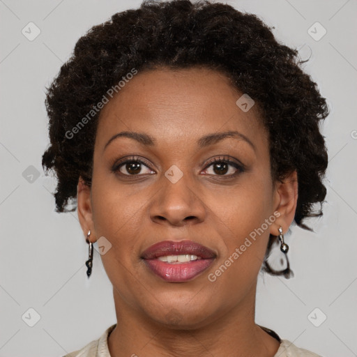 Joyful black adult female with short  brown hair and brown eyes