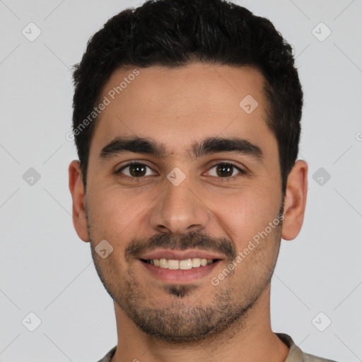 Joyful white young-adult male with short  black hair and brown eyes