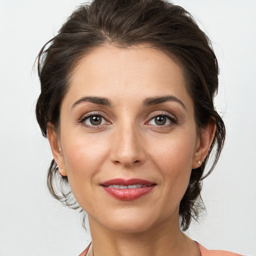 Joyful white young-adult female with medium  brown hair and brown eyes