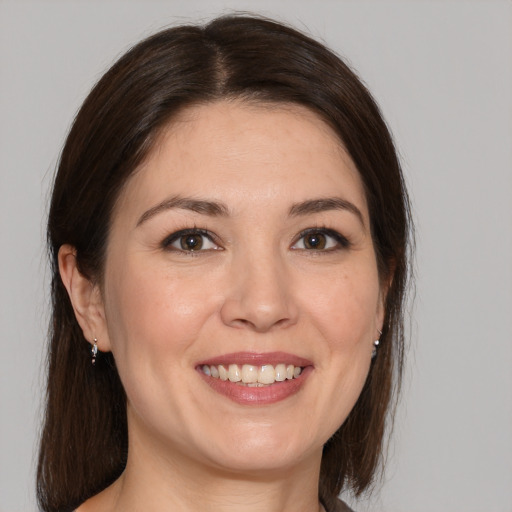 Joyful white young-adult female with medium  brown hair and brown eyes