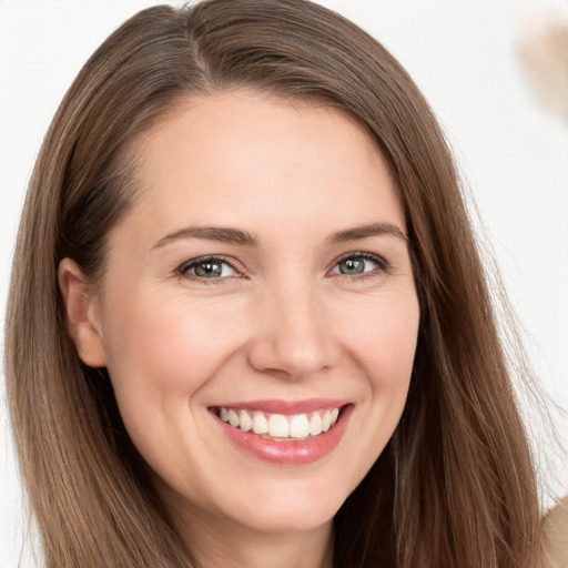 Joyful white young-adult female with long  brown hair and brown eyes