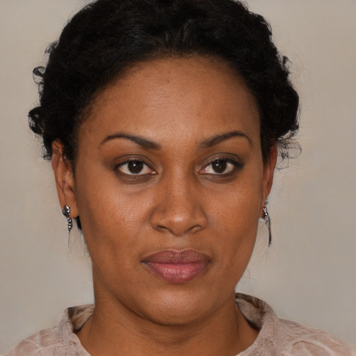 Joyful black adult female with short  black hair and brown eyes