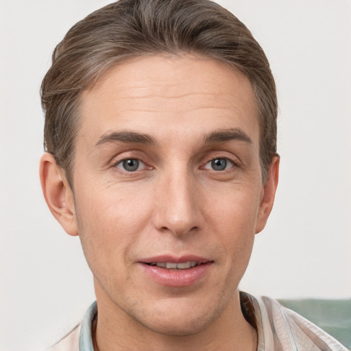 Joyful white adult male with short  brown hair and grey eyes