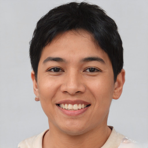 Joyful asian young-adult male with short  black hair and brown eyes