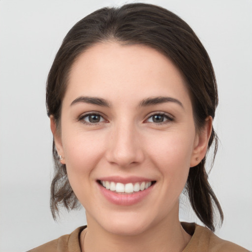 Joyful white young-adult female with medium  brown hair and brown eyes