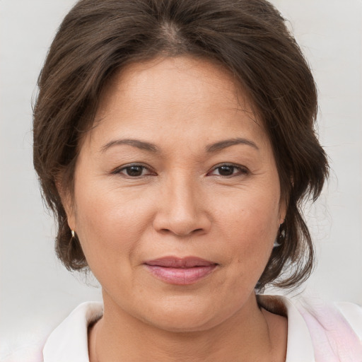 Joyful white adult female with medium  brown hair and brown eyes