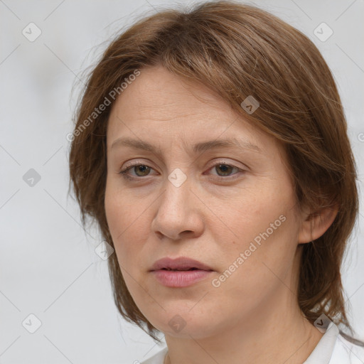 Joyful white adult female with medium  brown hair and grey eyes