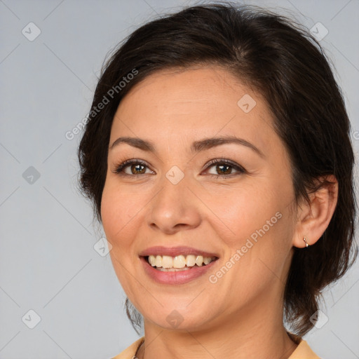 Joyful white adult female with medium  brown hair and brown eyes