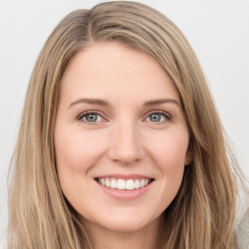 Joyful white young-adult female with long  brown hair and green eyes