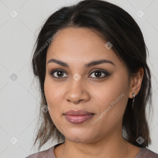 Joyful latino young-adult female with medium  brown hair and brown eyes