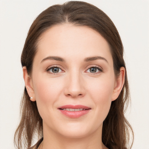 Joyful white young-adult female with long  brown hair and grey eyes