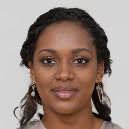 Joyful black young-adult female with medium  black hair and brown eyes