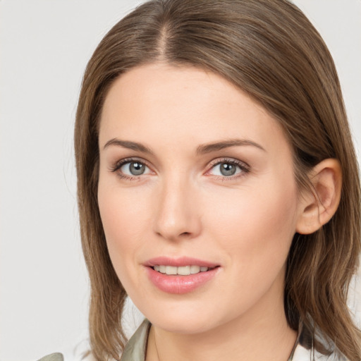 Joyful white young-adult female with medium  brown hair and green eyes