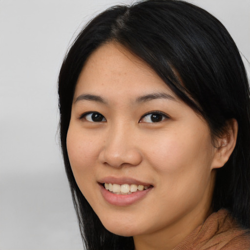 Joyful latino young-adult female with long  black hair and brown eyes