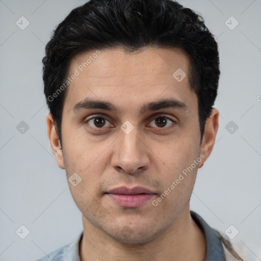 Joyful white young-adult male with short  black hair and brown eyes