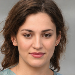 Joyful white young-adult female with medium  brown hair and green eyes