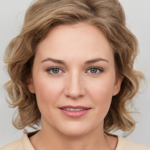 Joyful white young-adult female with medium  brown hair and blue eyes